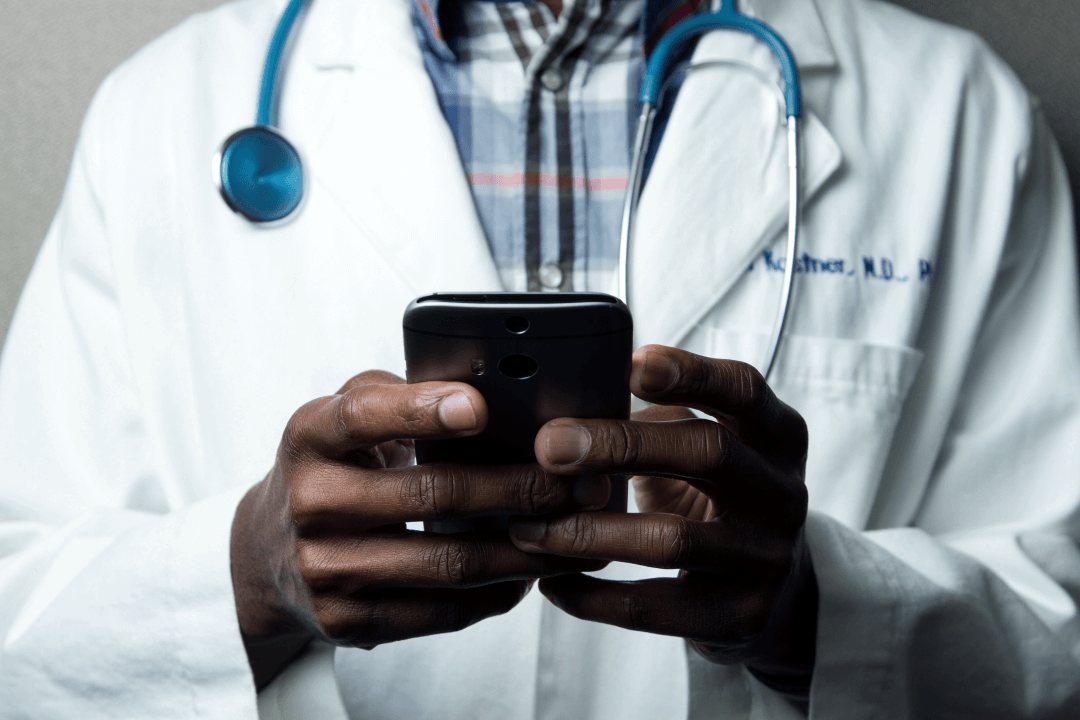 Doctor using a smartphone in a medical clinic